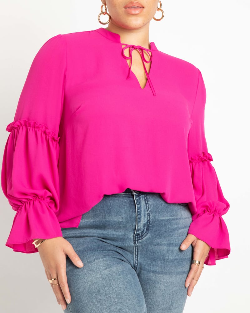 Side of a model wearing a size 28 Ruffle Detail Blouse With Ties in Pink by ELOQUII. | dia_product_style_image_id:295081